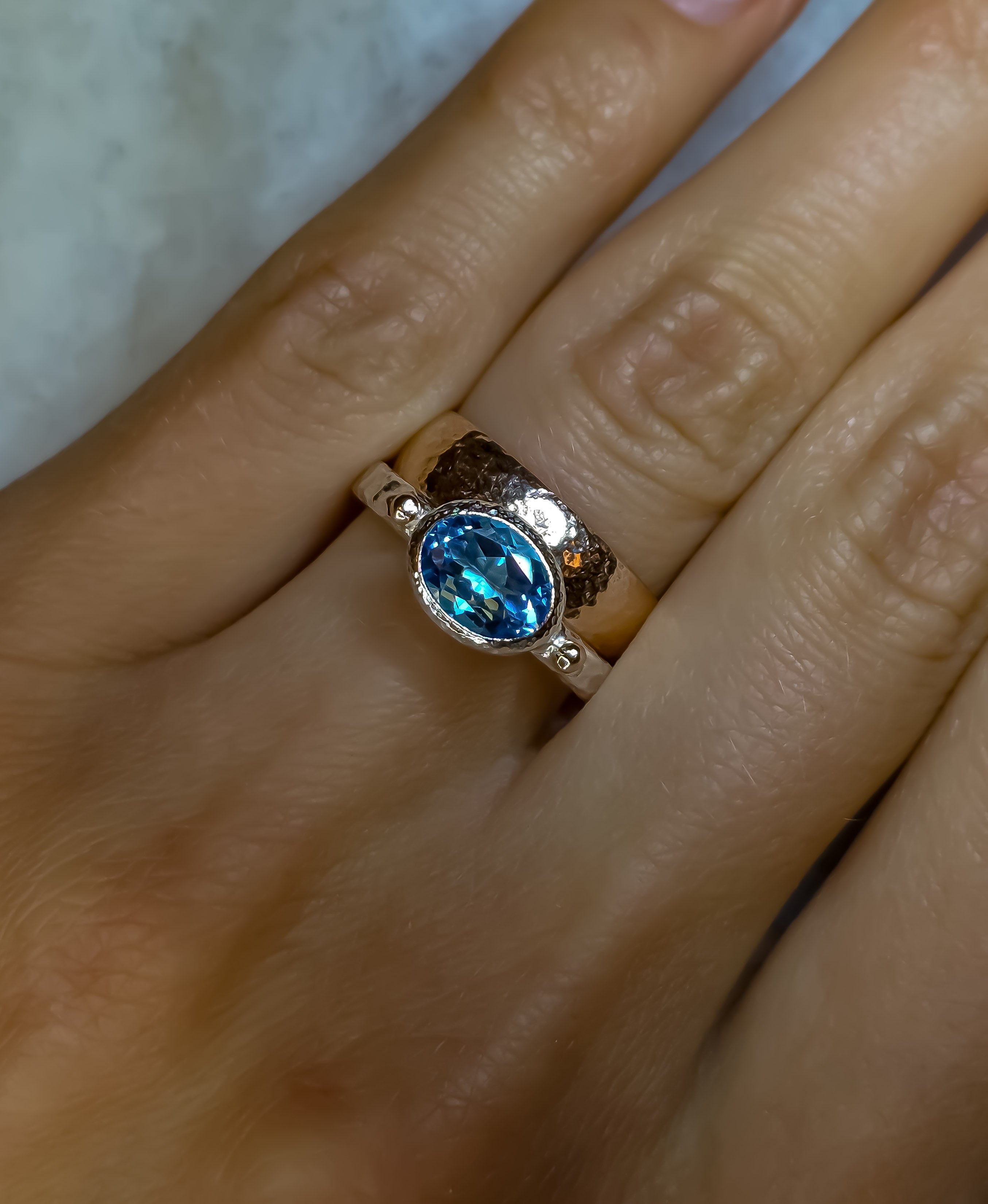 925 sterling silver ring with a natural Swiss Blue topaz and rose gold drops